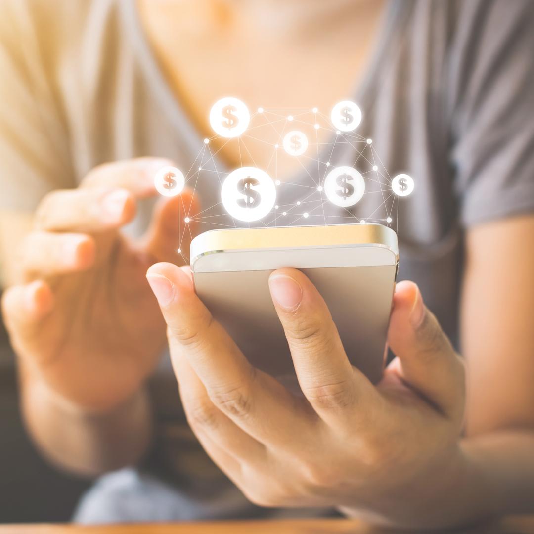 Closeup of woman on mobile device with dollar signs. Concept of ACH Transfers.