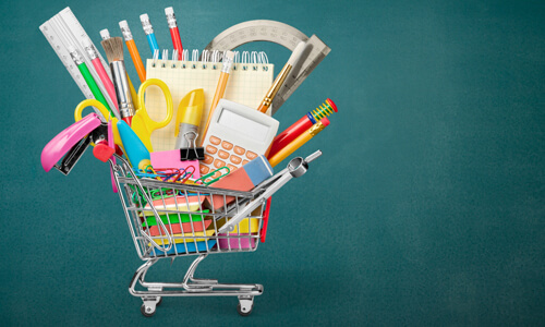 Shopping cart filled with back-to-school items and school supplies.