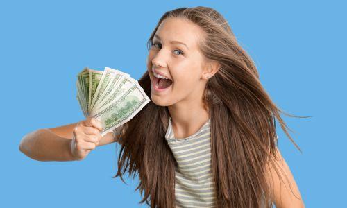 Young teen excitedly waves cash after participating in the April Balance Sweepstakes with Quorum.