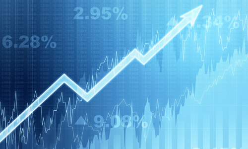 Investing concept: arrow trending up on blue stock exchange screen.