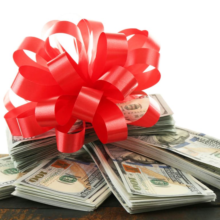 Bundles of cash with a holiday bow on top.