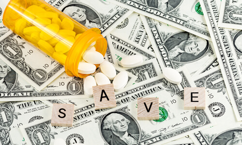 The letters "SAVE" on top of dollar bills and prescription pills.