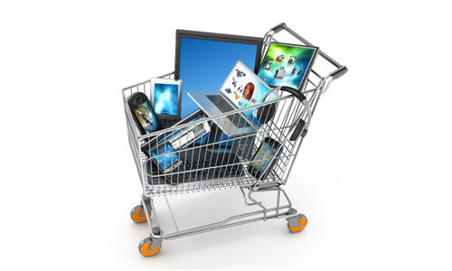 Shopping cart full of elecontrics devices, signifying black Friday sales.
