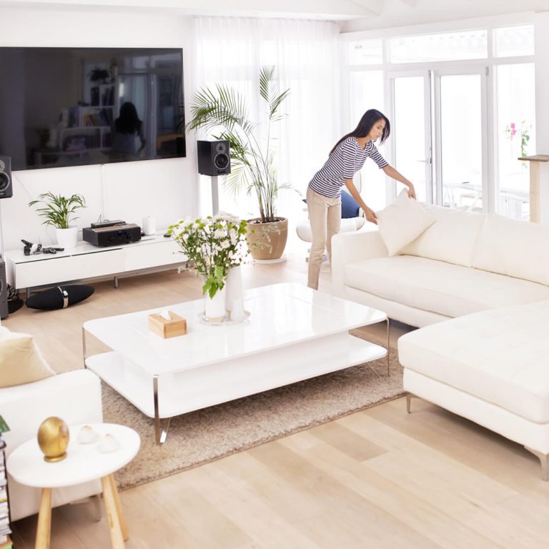 Woman staging her living room for potential home-buyers.