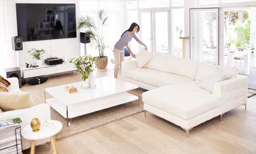 Woman staging her living room for potential home-buyers.