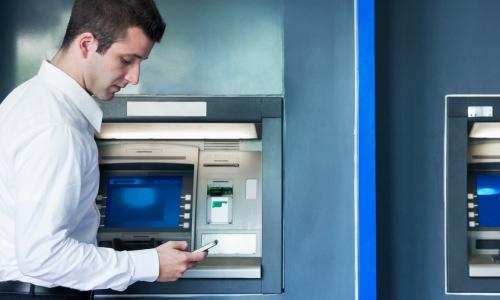 A man uses one of the 90,000 ATMs available to Quorum members.