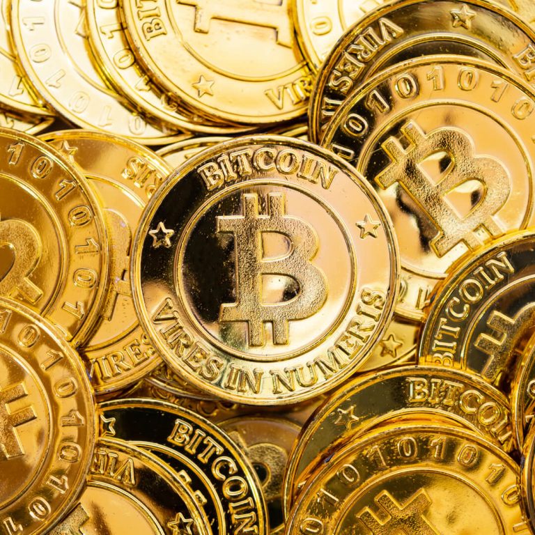 Bitcoin cryptocurrency background. A bunch of golden bitcoin. Digital currency.