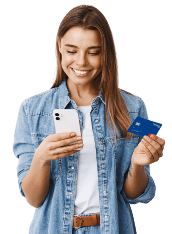 Woman looking at her phone while holding a Quorum debit card