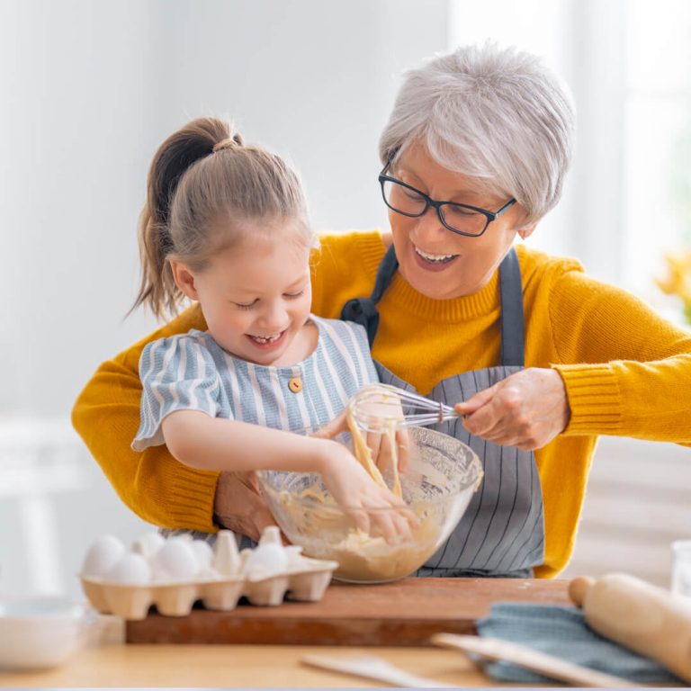 Grandmother in retirement baking with her granddaughter.