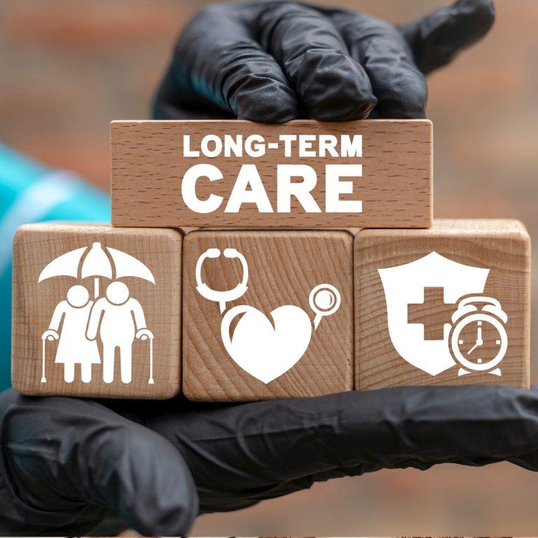 Long-Term Care building blocks, held by medical professional with medical gloves