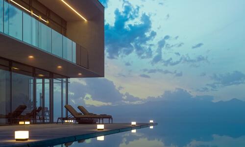 Luxury Real Estate Investment Property with infinity pool at sunset.