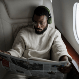 Man Reading Newspaper On Airplane