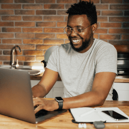 Man Smiling On Laptop