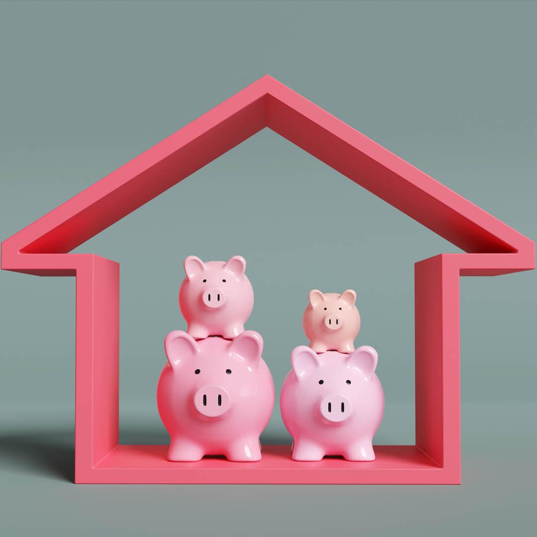 Toy pigs in house, illustrating concept of a piggyback mortgage.