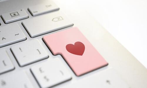 Romance Scams - heart on Return key of computer keyboard.