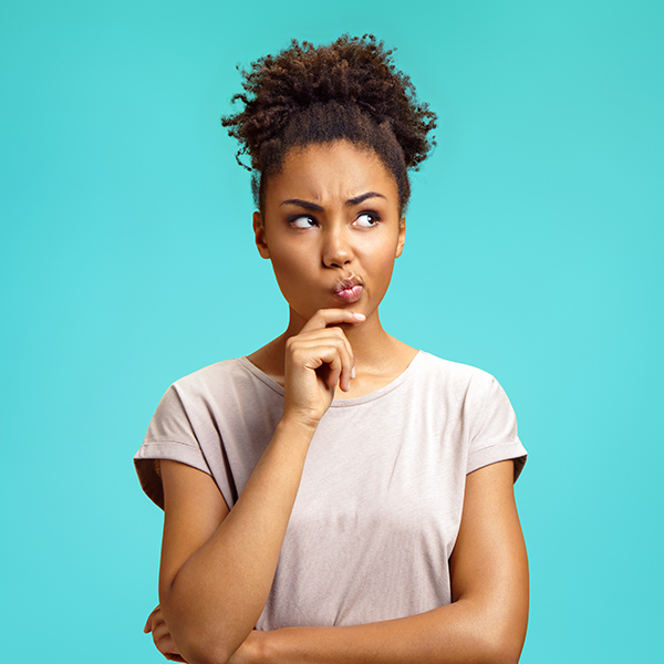 a young woman thinking and looking off to the side